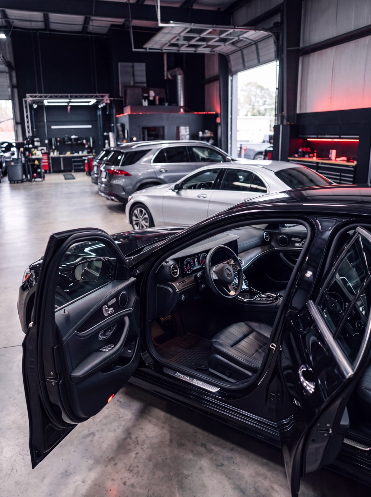 DTB Auto Recon shop bay with multiple vehicles being reconditioned