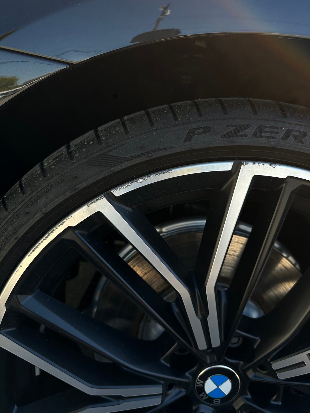 BMW alloy wheel before, with curb rash on the lip