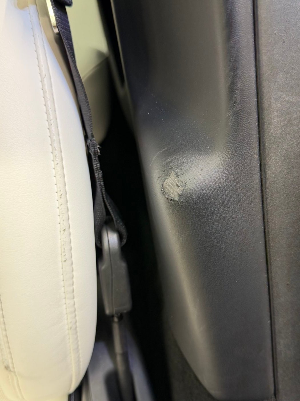 B-pillar trim before, with a torn corner