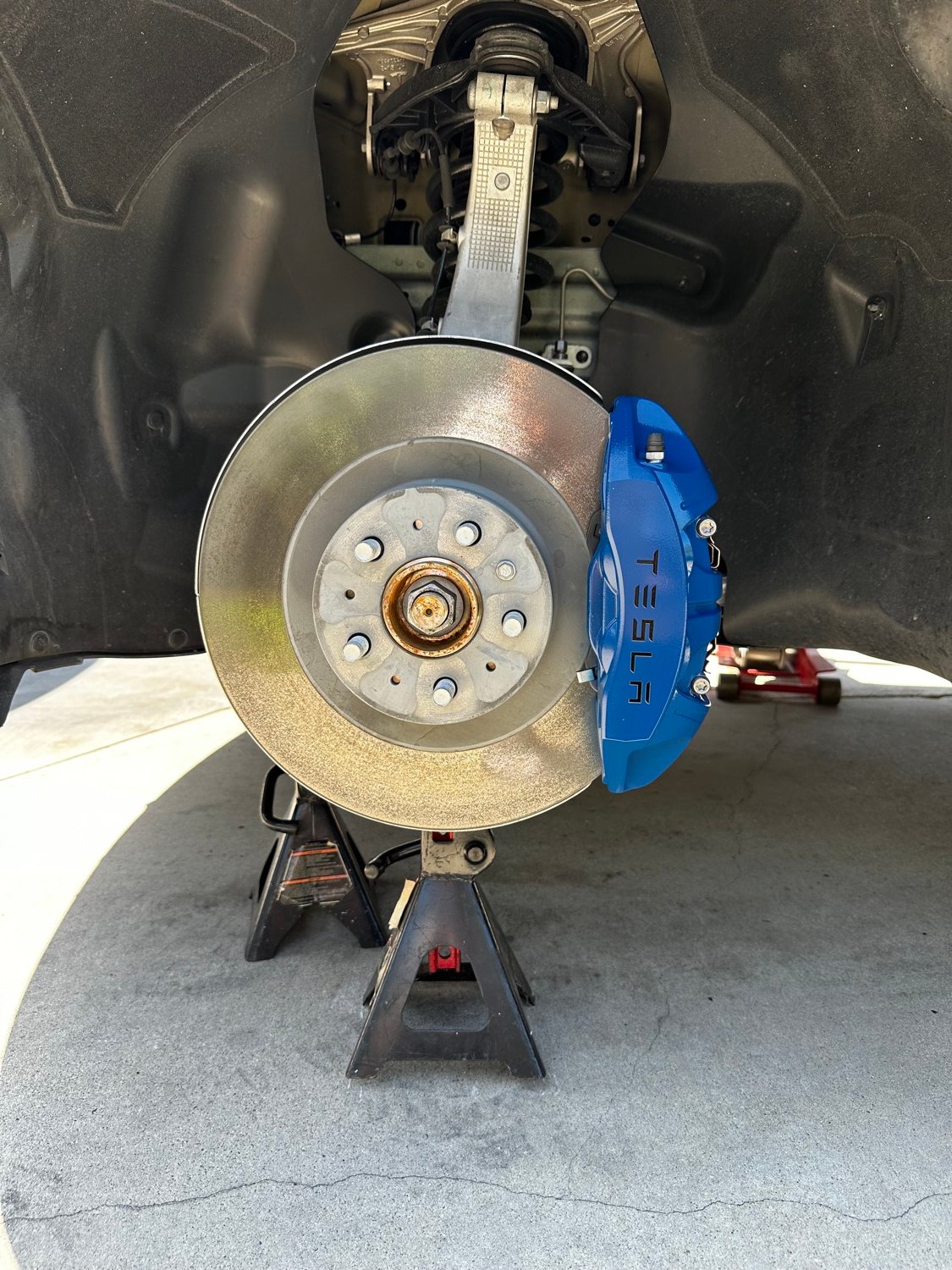 Tesla brake caliper after painting a new blue color
