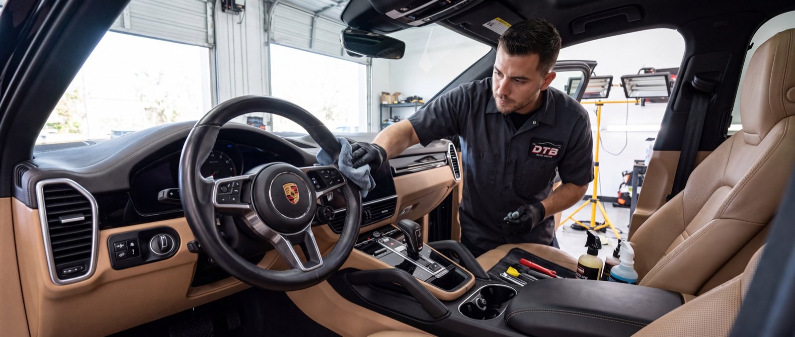 A DTB Auto Recon technician detailing a Porsche interior