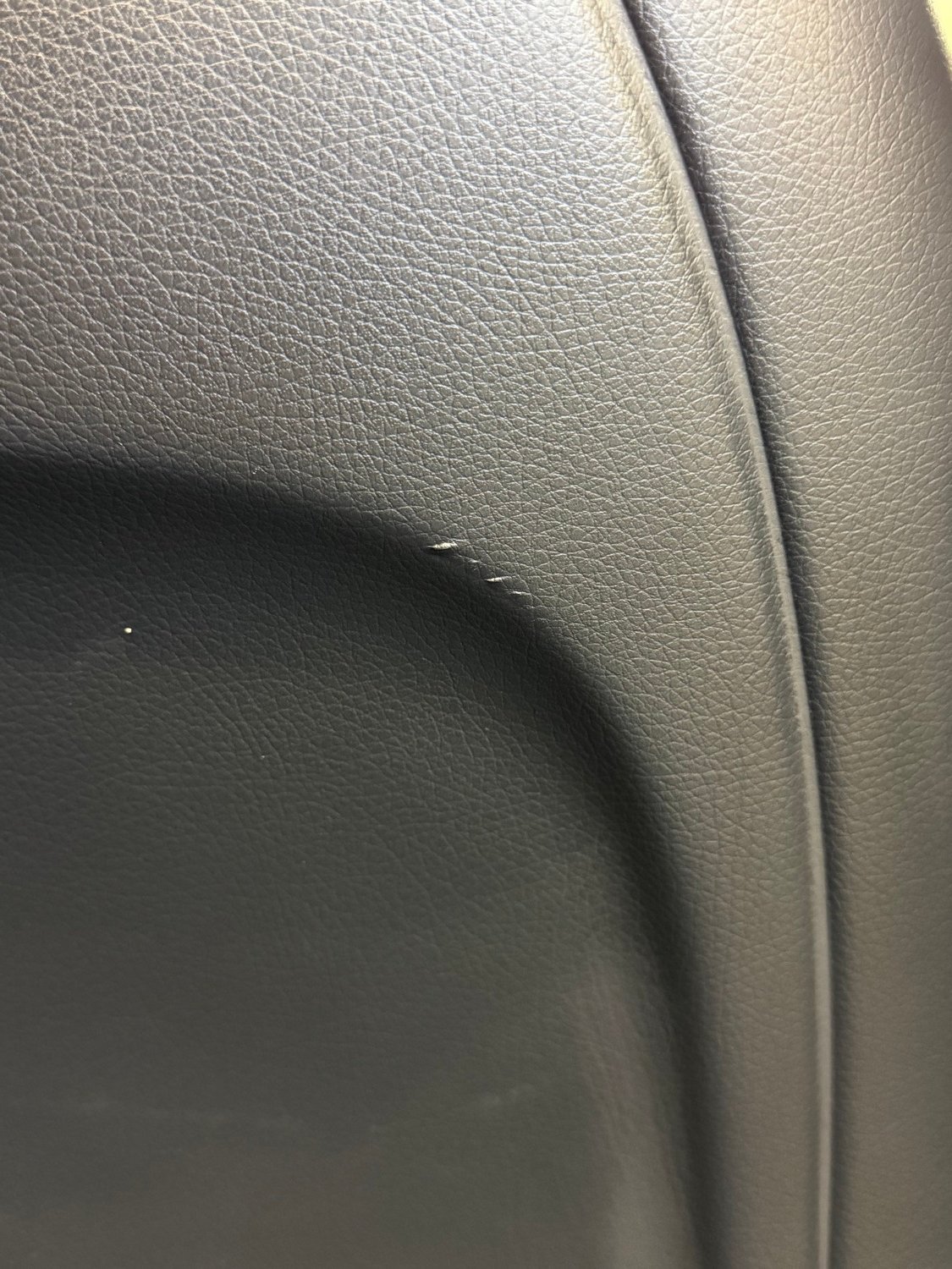 Black leather rear seat before restoration