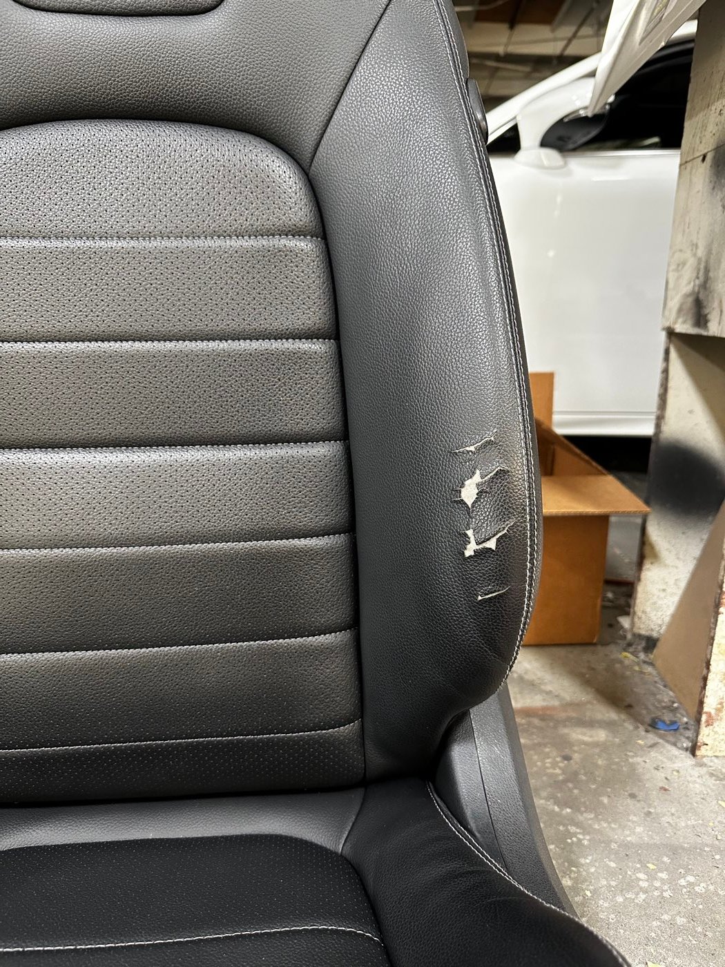Black leather seat before restoration