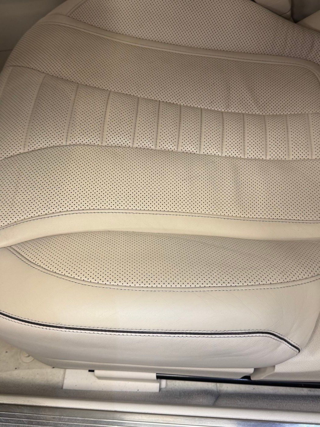 Cream perforated leather seat after reconditioning
