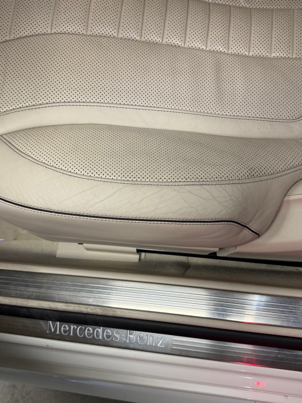 Cream perforated leather seat before reconditioning