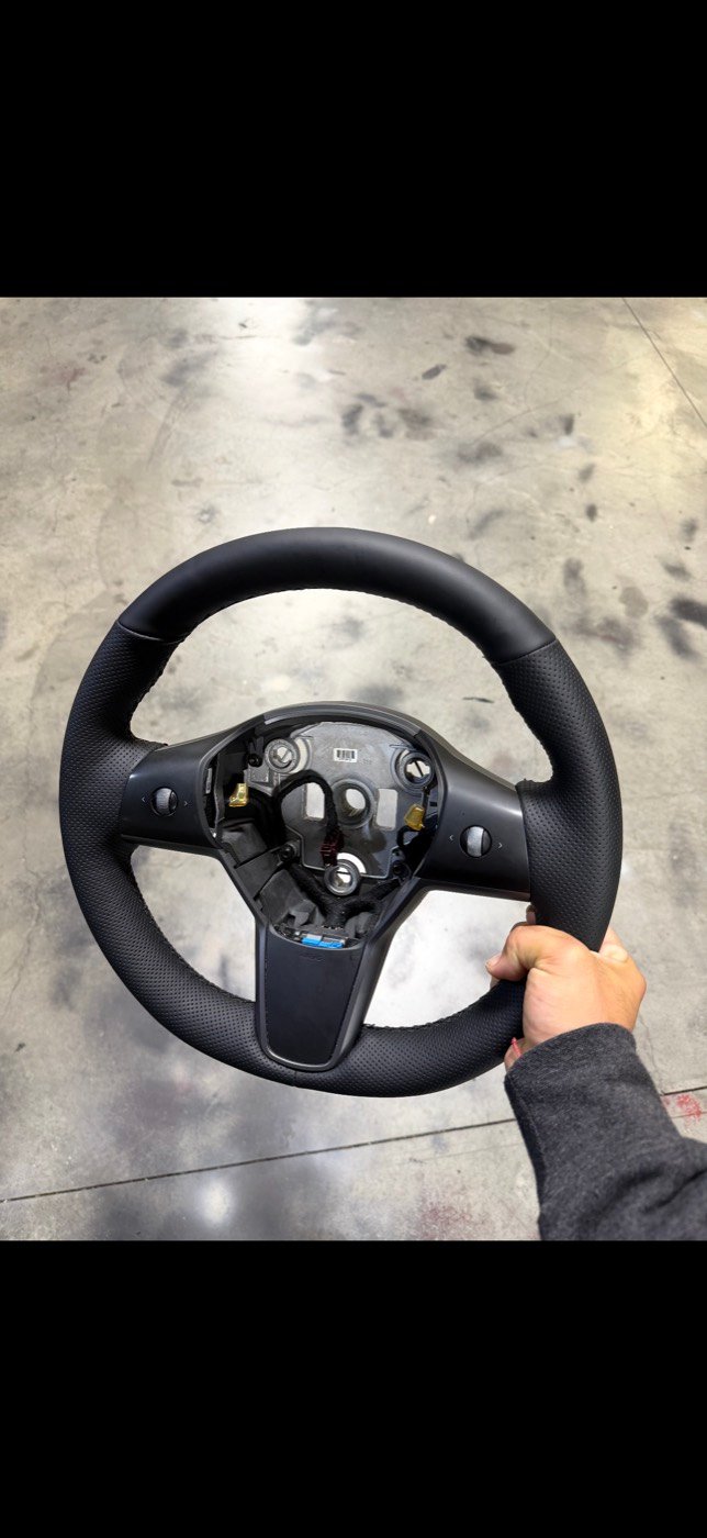 Tesla steering wheel after perforated leather restoration