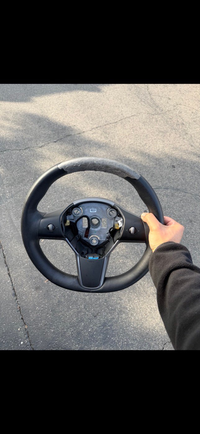 Tesla steering wheel before restoration